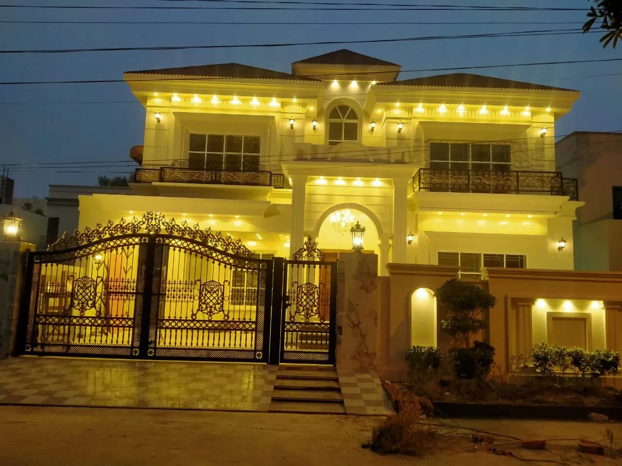 36 Jehlum — A classic gated elevation with a sculptural spiral staircase, DC Colony, Gujranwala