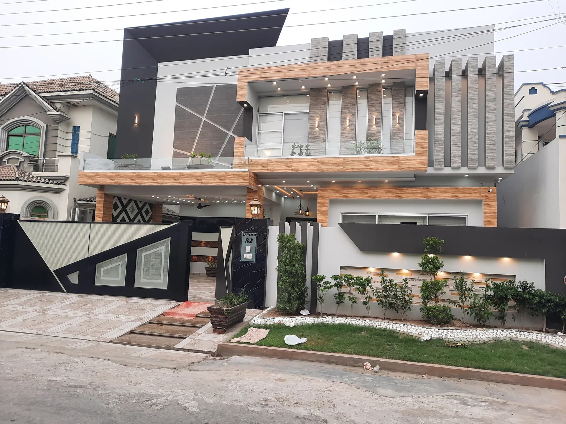 82 Jehlum — Our flagship residence: a wide dusk-lit elevation, DC Colony, Gujranwala